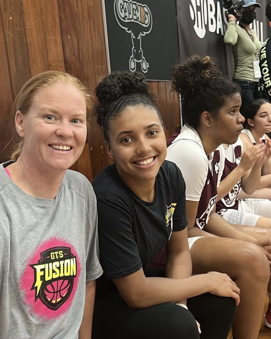 Katie Fudd courtside with a player during a tournament